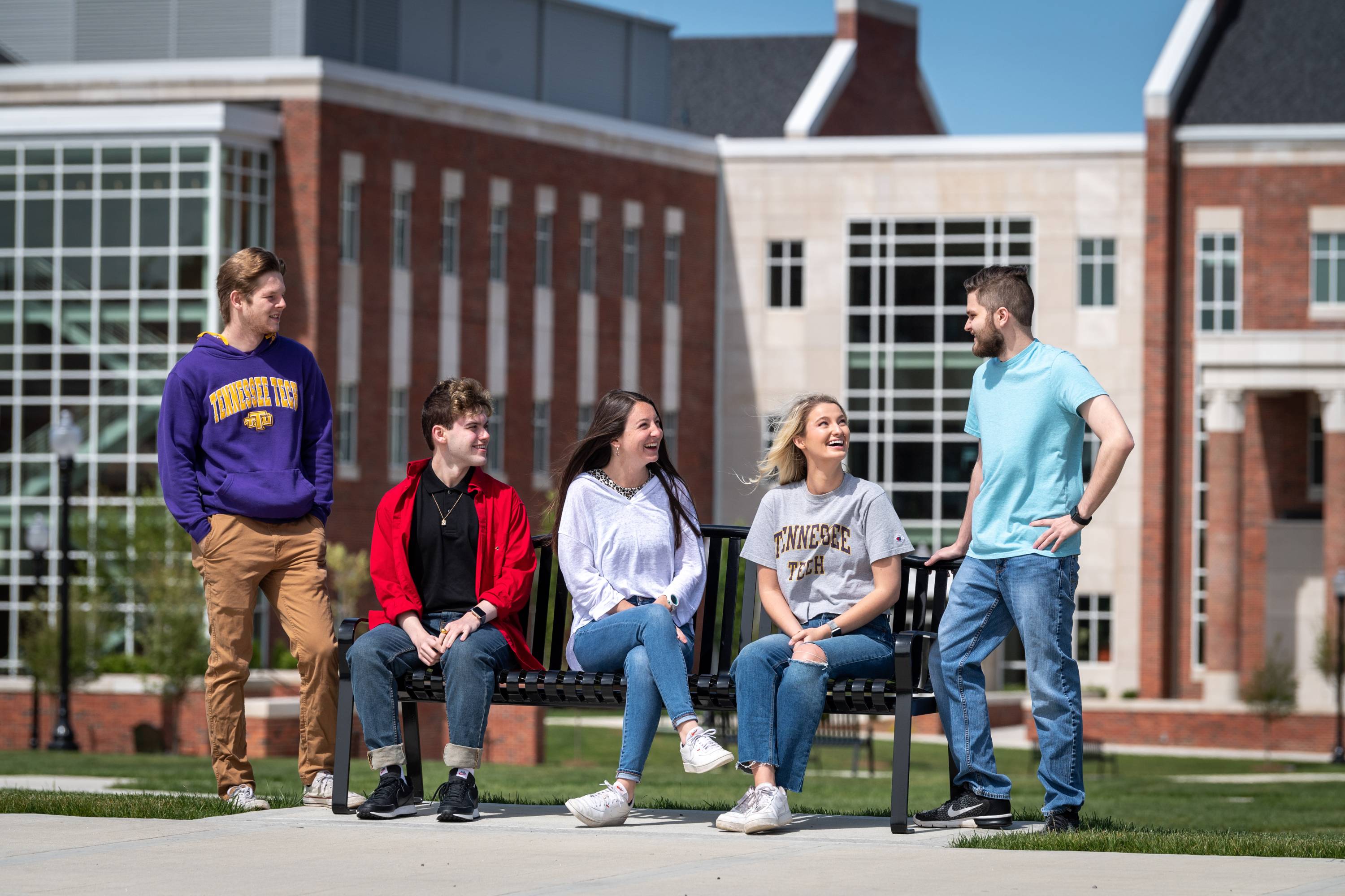 A group of students talking in front of the Lab Science Commons