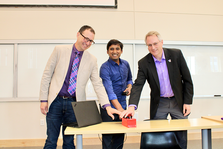 Pressing the ceremonial button to open Tennessee Tech's Science DMZ 