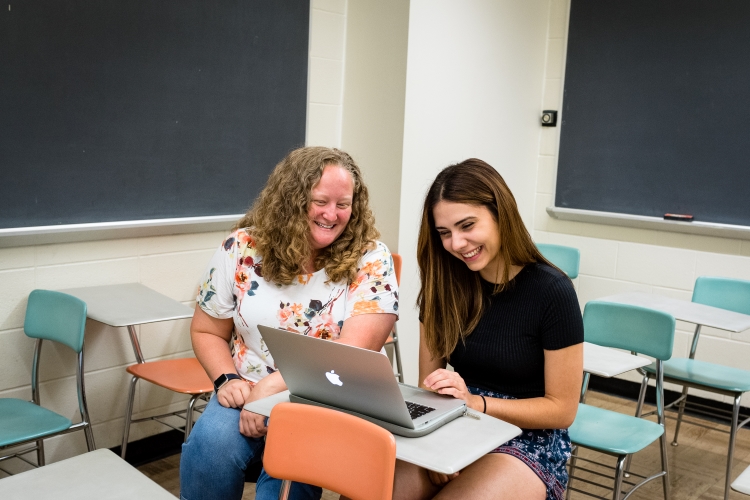 student and parent looking at laptop