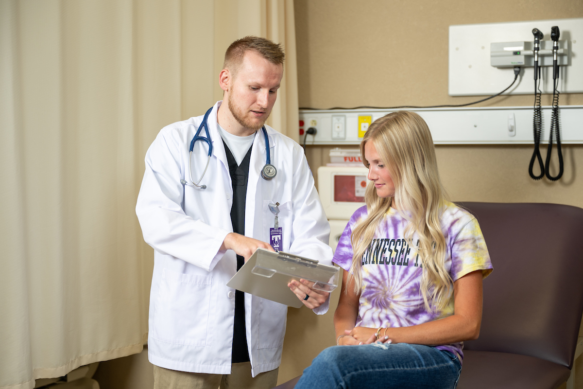 A nurse speaking to a patient