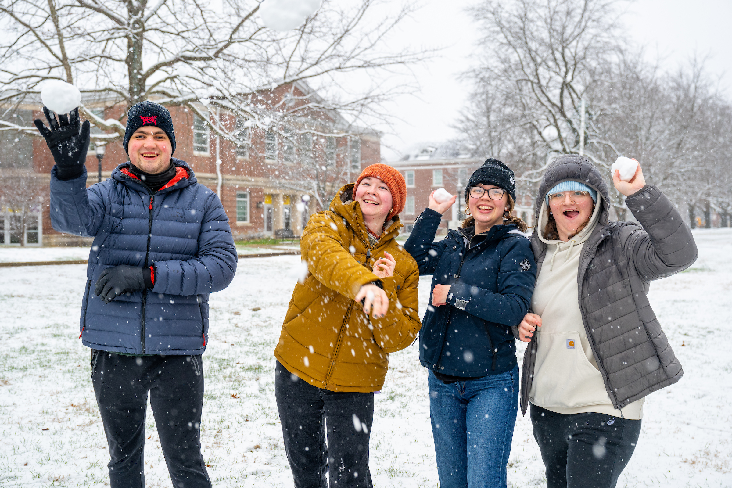 students playing with snowballs