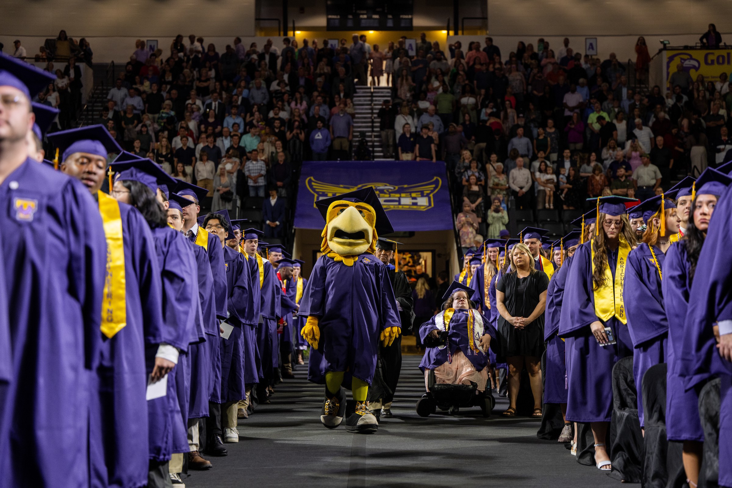 Awesome Eagle greets graduating students during the university's morning commencement ceremony.