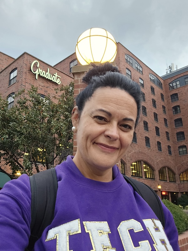 Jennifer Murphy in front of Graduate sign