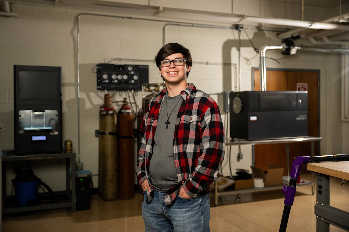 Colin Hill stands in a lab