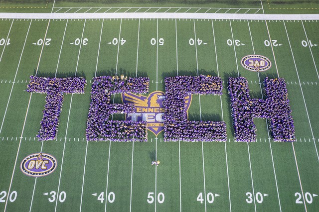 students form the letters T-E-C-H on Overall Field