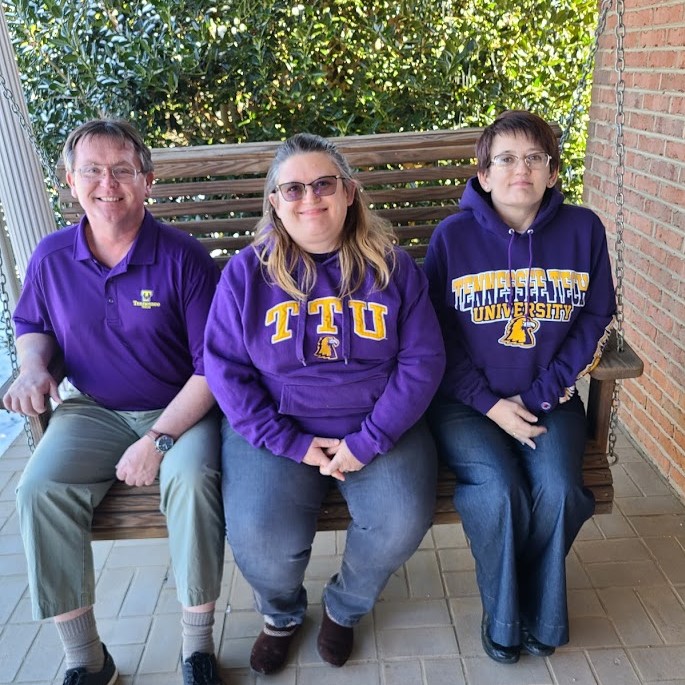 A photo of Lelia and her siblings on a porch swing