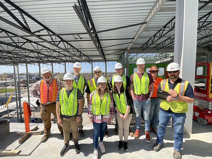 Students in hard hats visit the Ashraf Islam Engineering Building construction site.