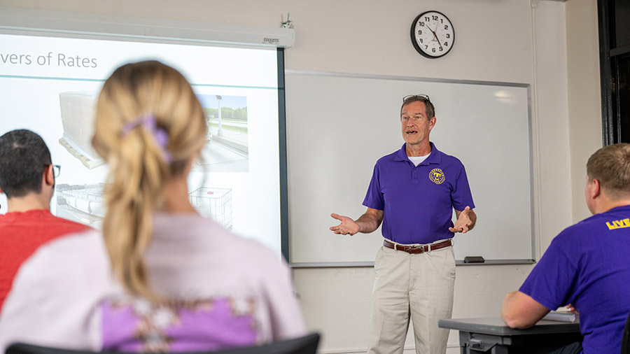 A professor standing in front of a class.